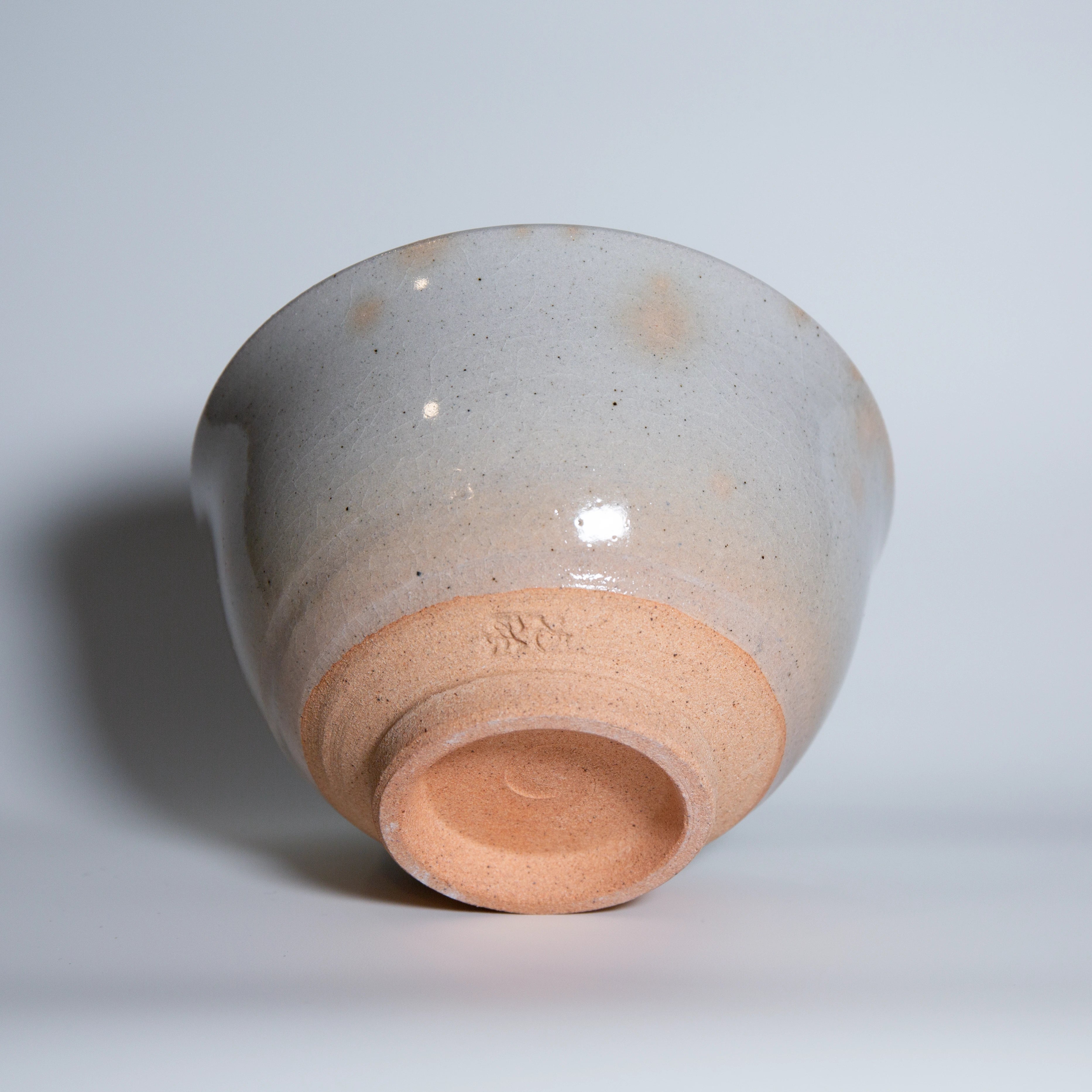 Underside of Yamaki Ikai mist grey matcha bowl showing the unglazed pottery foot